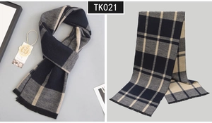 Detail view of premium wool scarf with classic plaid pattern and fringe edging