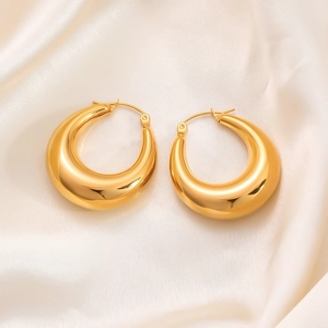 Luxurious 18K gold plated stainless steel teardrop hoop earrings on champagne silk fabric