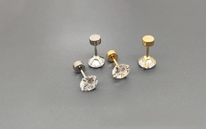 Close-up of 316L stainless steel stud earrings with round zircon and flat screw backs