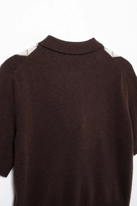 Macro detail of dark brown knit polo shirt with ivory argyle pattern on the shoulder
