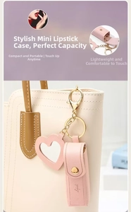 Detail view of pink leather mini lipstick bag charm with heart mirror and metal clasp