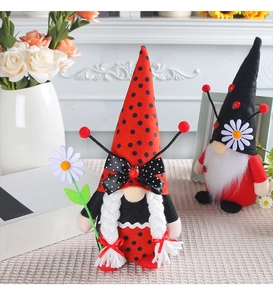 Close-up of creative ladybug gnome dolls with knit hats and daisy accents for holiday decor