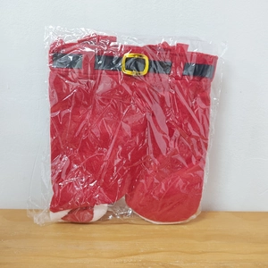 Detailed view of red Santa pants holiday decoration in plastic bag with black belt