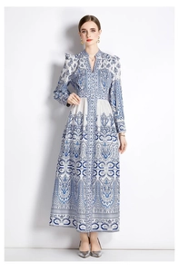 Detail of blue and white porcelain print on a V-neck maxi dress with lantern sleeves