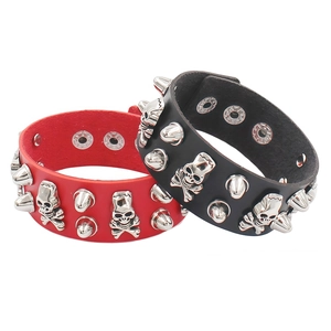 Detail showing red and black punk leather wristbands with skull and spike studs