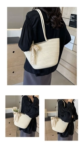 Detail of cream woven tote bag featuring delicate lace bow and intricate knit texture