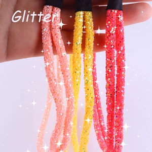 Three glitter elastic hair bands in pink, yellow and red colors for women's hair styling