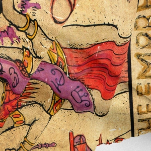 Detail of bohemian tapestry fabric showing vintage heraldic prints and fiber texture