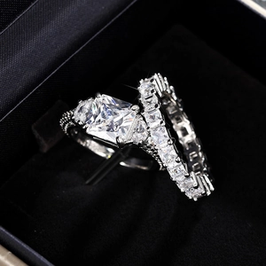 Detailed macro view of a silver tiered eternity wedding set in a black velvet jewelry box