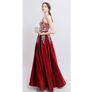 Elegant one-shoulder evening gown with white floral embroidery and red satin skirt
