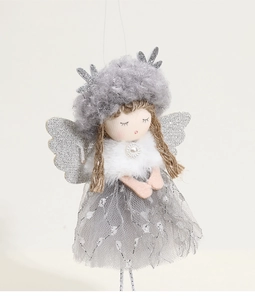 Macro view of plush Christmas angel ornament with silver wings and grey mesh dress details