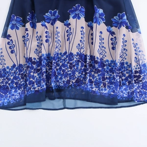 Elegant floral print chiffon maxi dress featuring blue flowers and tie neck detail