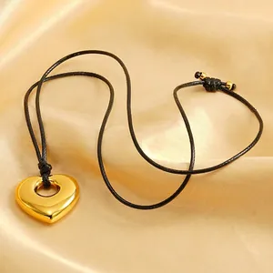 Minimalist gold hollow heart pendant on adjustable black cord with gold bead accents
