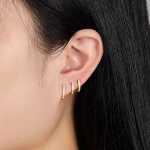 Macro shot of gold plated silver ear cuffs with cubic zirconia in a tiered ear styling
