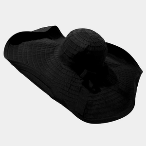 Detail of wide brim black sun hat with elegant ribbon decoration and wavy edge design