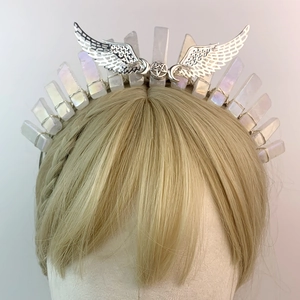 Silver bridal headband with crystal shards and metal wings on a mannequin head