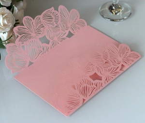 Detailed laser-cut hollow rose pattern on pink pearlescent paper invitation cover