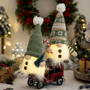 Christmas gnome plush dolls on red vintage car with glowing beards and knit hats