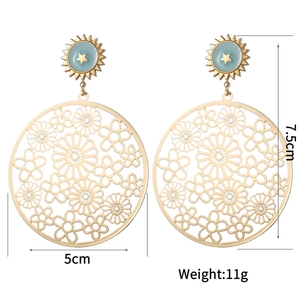 Detailed view of vintage gold hollow earrings with size marks 5cm wide and 7.5cm high