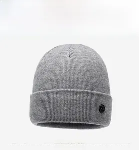 Detailed texture of grey knit beanie featuring a black circular embossed side label