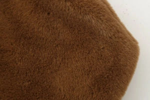 Detailed close-up of soft brown faux fur fabric showing plush texture and fiber density