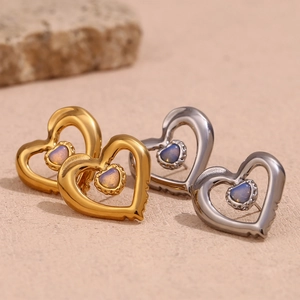 Detail of double heart earrings in gold and silver finish with natural moonstone inlay
