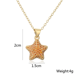 Detailed size view of a 18K gold star pendant with orange zircons showing 2cm height