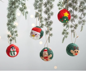 Felt Christmas ornaments featuring Santa, reindeer and tree hanging on a pine branch