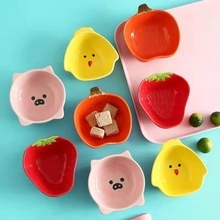 Detailed top view of assorted mini ceramic animal and fruit shaped snack dishes