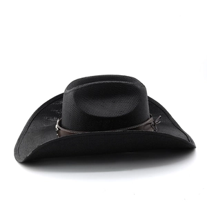 Close-up of black straw cowboy hat with brown leather band and intricate weaving texture
