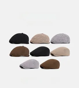 Detail shot of vintage newsboy caps in black, khaki and grey textured cotton fabrics