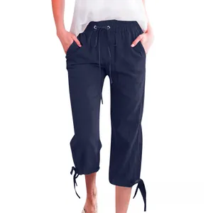 Close-up of drawstring elastic waist and adjustable bow-tie hem on navy linen trousers