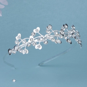 Detailed view of silver crystal tiara headband with heart and leaf rhinestone pattern