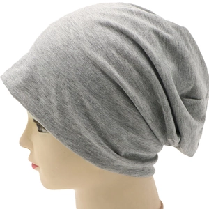 Close-up of gray knit slouchy beanie showing detailed soft texture and ribbed cuffs