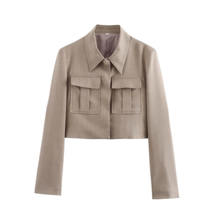 Detailed view of khaki cropped blazer featuring pointed lapels and pleated flap pockets