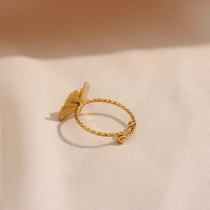 Macro detail of adjustable butterfly ring in 18K gold plated twisted metal band