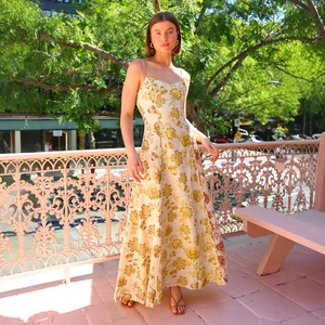 Close-up of the elegant floral print and delicate spaghetti straps on this maxi dress