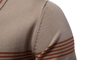 Detail of shoulder seam and fine knit texture on khaki striped polo shirt