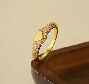 Detailed view of 925 silver gold-plated heart ring with micro-pave white cubic zirconia