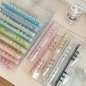 Close-up of clear PVC binder covers with various colored rings in 6-hole metal design