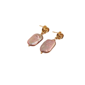 Baroque irregular pearl earrings with gold rose flower design for women on white background
