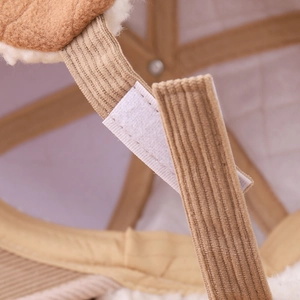 Detail of adjustable velcro strap on khaki corduroy winter hat with faux shearling lining