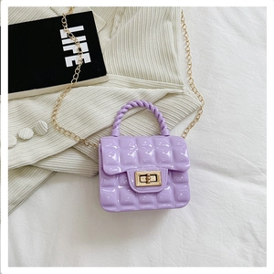 Detailed close-up of purple PVC quilted mini bag with gold chain and metal hardware