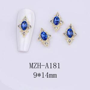 Detail of 9x14mm blue oval gemstone nail charm with gold frame and small white crystals