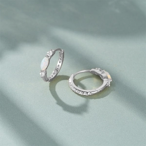 Macro detail of S925 sterling silver hoop earrings with marquise opal and zircon inlay