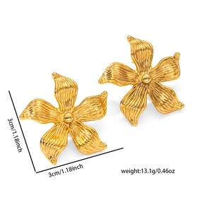 Detailed view of gold flower earrings showing 3cm size and brushed metal texture