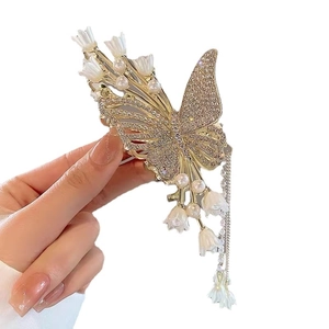 Elegant golden butterfly hair claw clip with tassels, white pearls and resin lily flowers