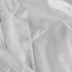 Macro shot of silver sequin fabric texture with metallic luster for three-piece set