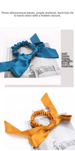 Detail of silk bow scrunchie set in peacock blue and mustard yellow with long ribbons