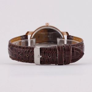 Fashionable quartz watch with brown leather strap and rose gold case on a display stand